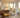 Z-Wave plug-in dimmer and a softly lit lamp in a warm mid-century modern room, with cyan rings showing Long Range coverage