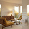 Z-Wave plug-in dimmer and a softly lit lamp in a warm mid-century modern room, with cyan rings showing Long Range coverage